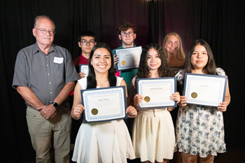 Group of students holding certificates.