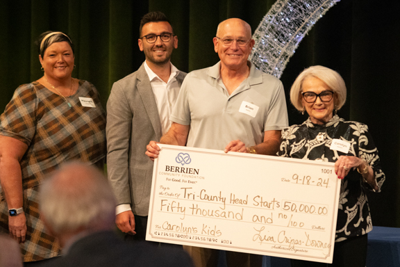 Group of people holding a check