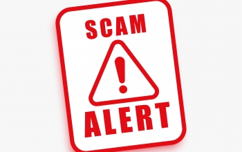 red warning sign that says, "Scam Alert"